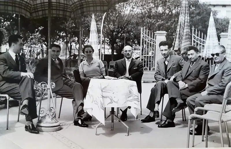 Teresio and colleagues sitting outdoors at a small table